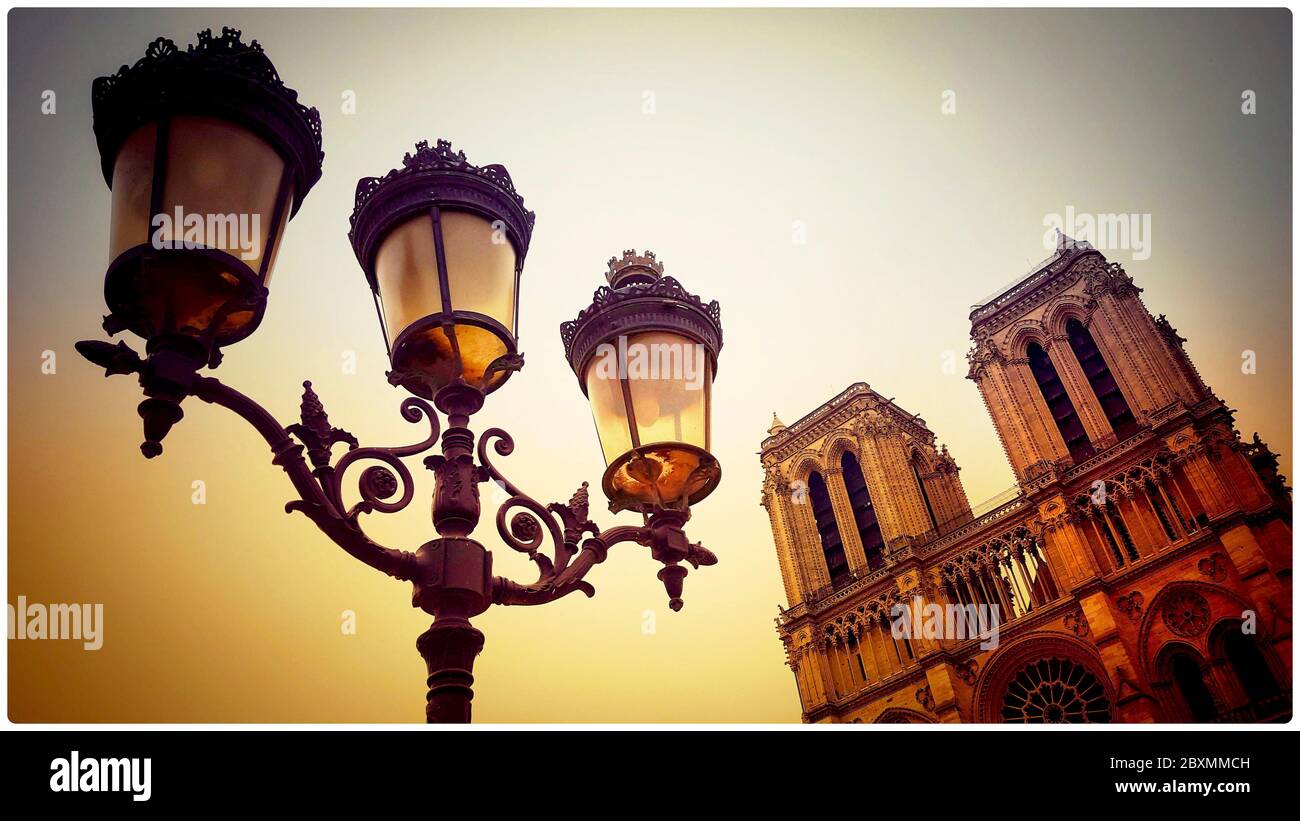 Street light with the western facade of Notre-Dame de Paris in the background, France Stock Photo