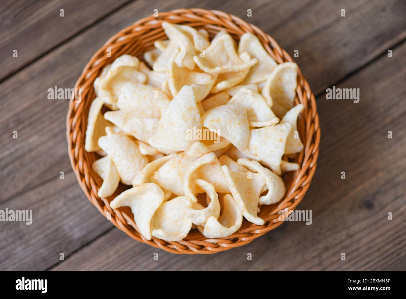 prawn crackers chips on basket and wooden table background / homemade
