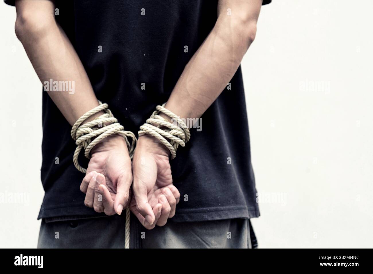 The man was bundle cross the arms by rope / Slave Stock Photo