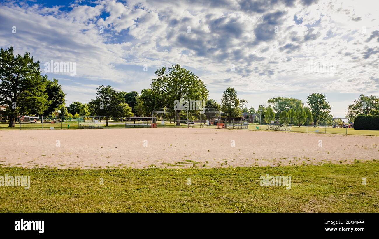 the view from the outfield of a youth baseball field in a city park Stock Photo