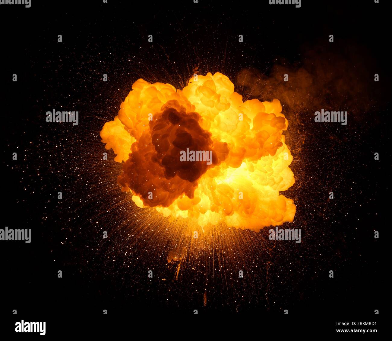 Fiery bomb explosion with sparks isolated on black background. Texture photography of fire and smoke. Stock Photo