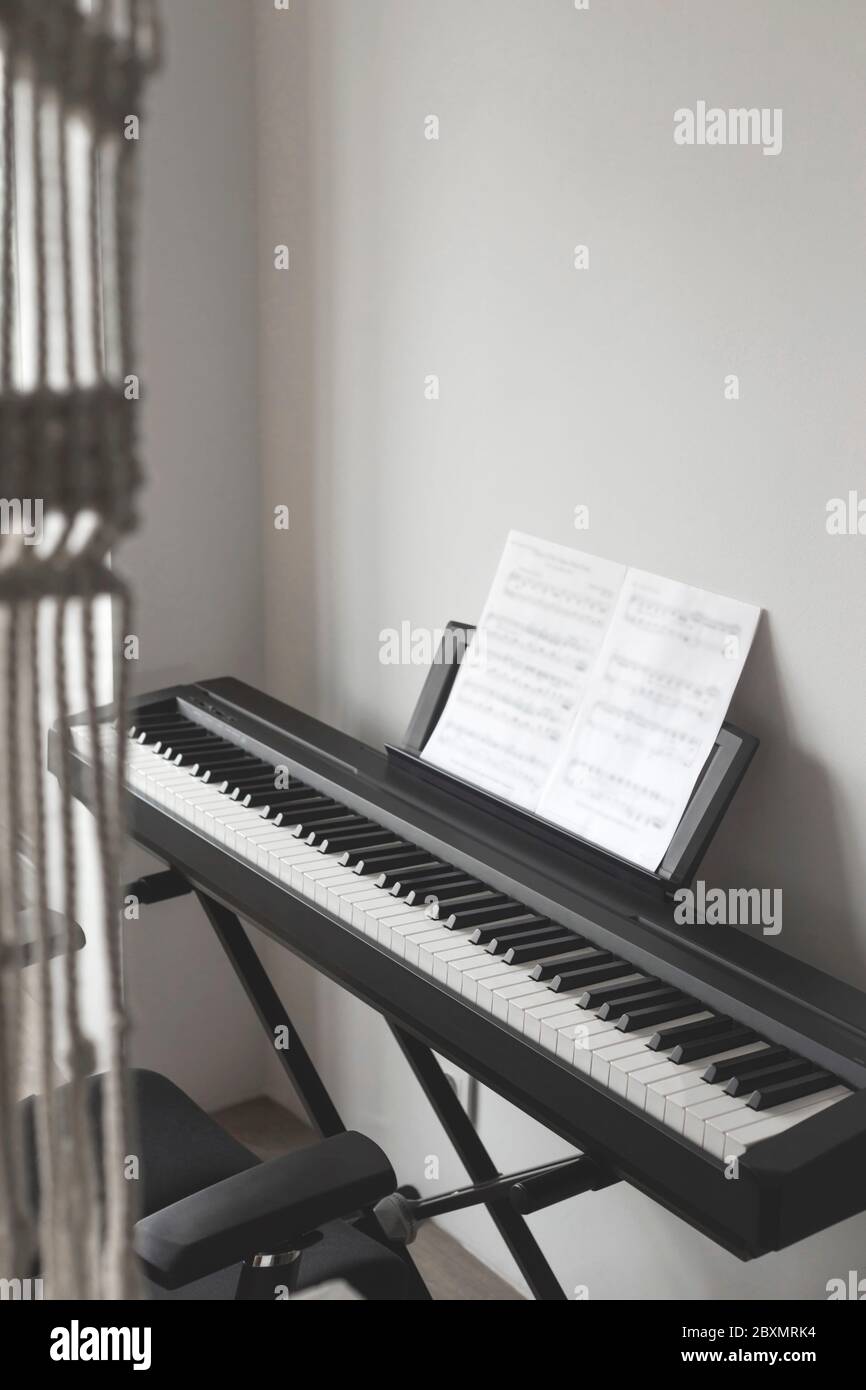 Learn music at home on an electronic piano concept. Stock Photo