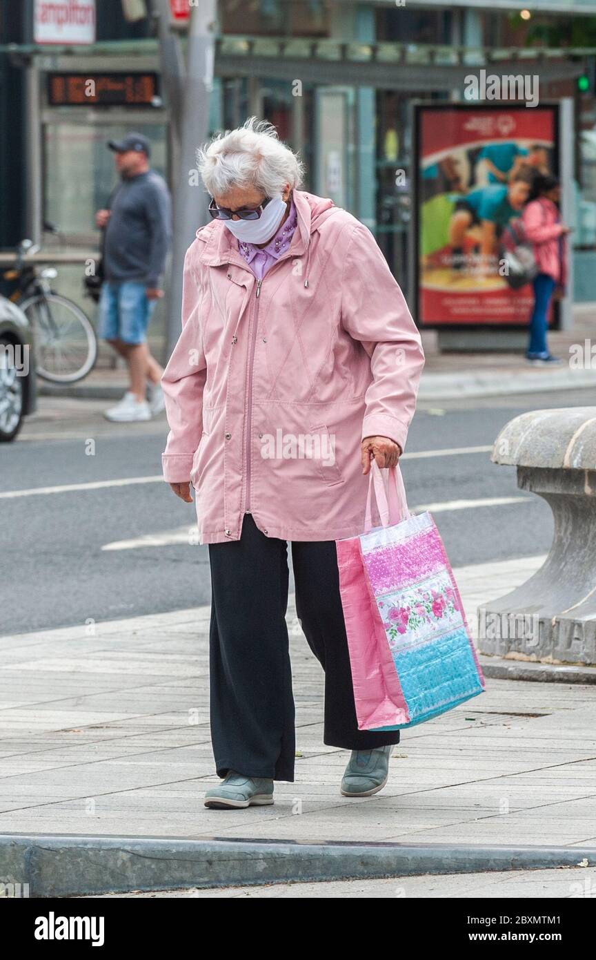 Cork, Ireland. 8th June, 2020. Many shops in Ireland are re-opening today after a 3 month closure due to the Covid-19 pandemic. A woman wears a face mask to protect herself from Covid-19 on Grand Parade, Cork. Credit: AG News/Alamy Live News Stock Photo