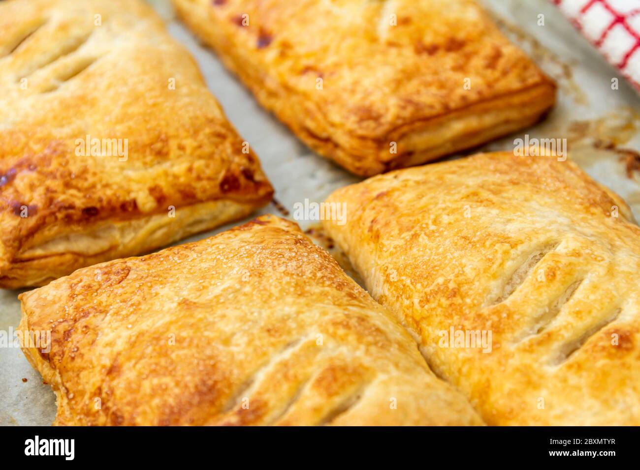 Four Apple Pies on a baking tray straight out of the oven Stock Photo