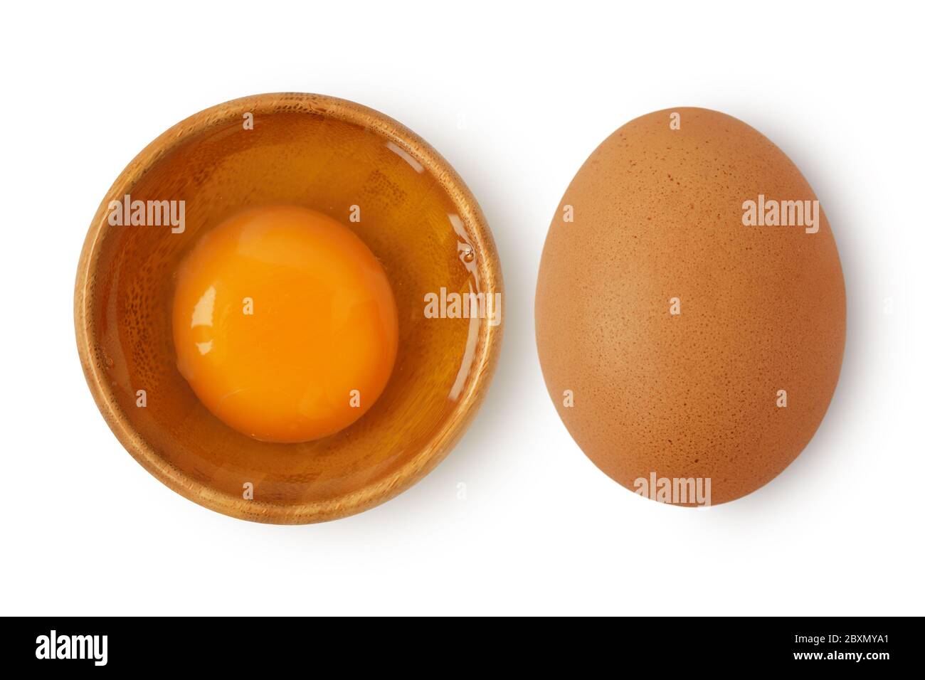 Egg in wooden bowl and egg with shell on white background Stock Photo