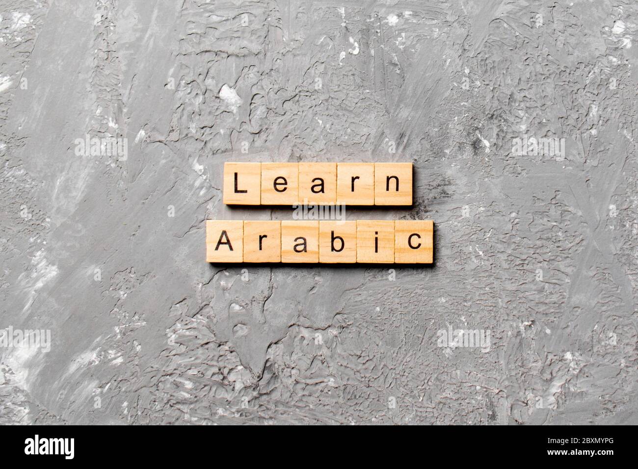 learn arabic word written on wood block. learn arabic text on table, concept. Stock Photo