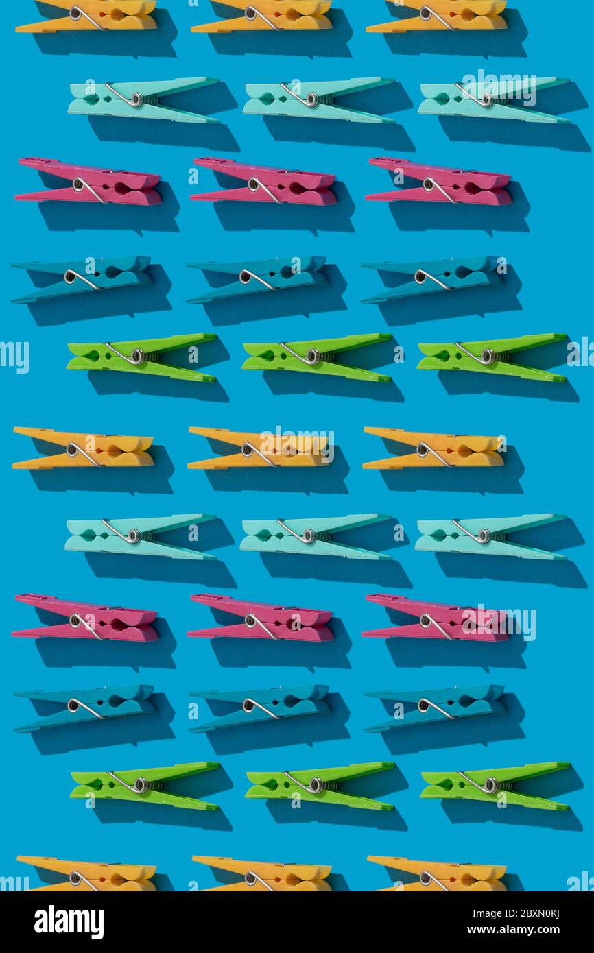 Clothes pins as pattern on blue background Stock Photo