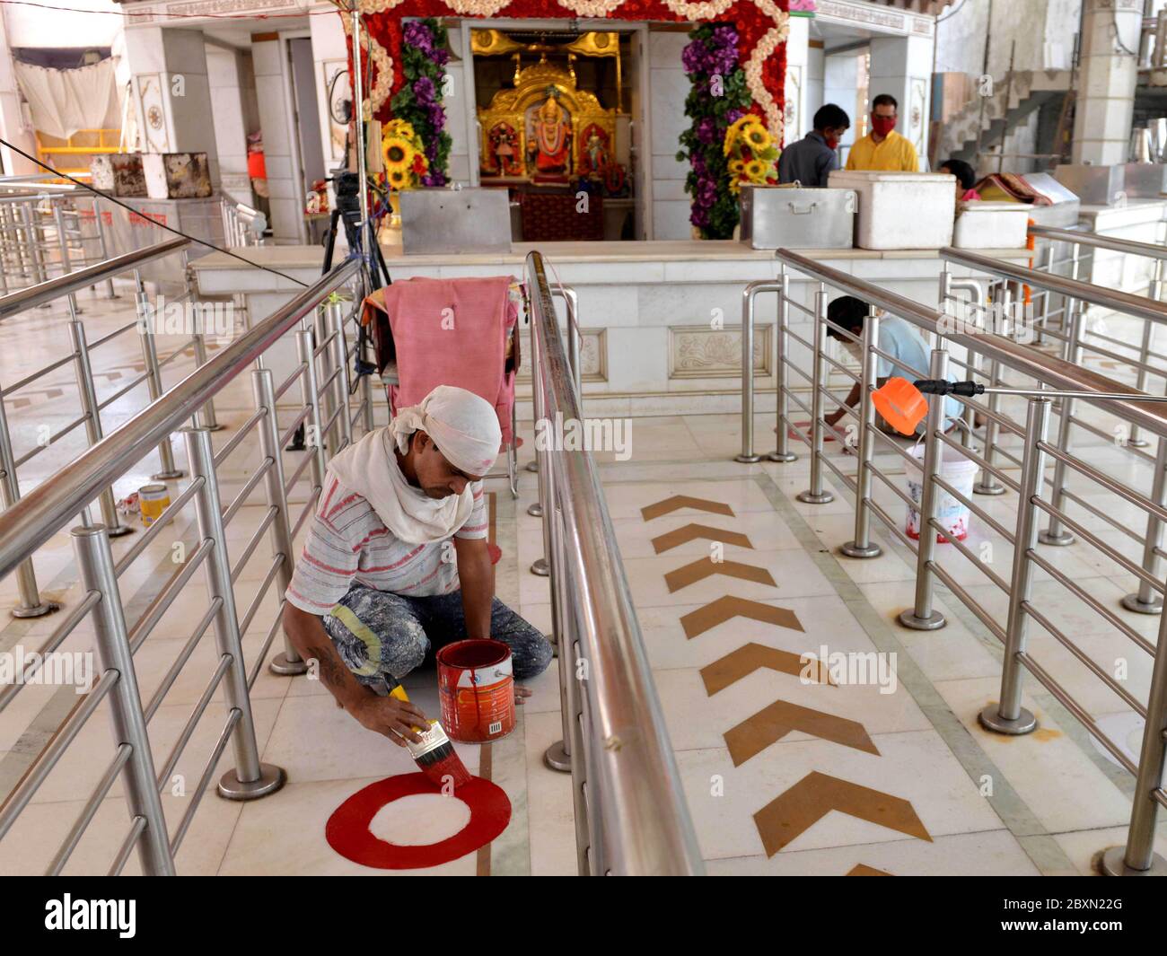 (200608) -- NEW DELHI, June 8, 2020 (Xinhua) -- Workers draw social-distancing markers at the entrance of a temple in New Delhi, India, June 6, 2020. People thronged into places of worship like temples, mosques, churches, and gurudwaras (for Sikh community) in India on Monday as religious places reopened across many states after 76 days of lockdown due to COVID-19. The reopening of religious places was permitted by fresh guidelines issued by the federal government on June 4, which stated "Religious places or places of worship for public in containment zones shall remain closed. Only those Stock Photo