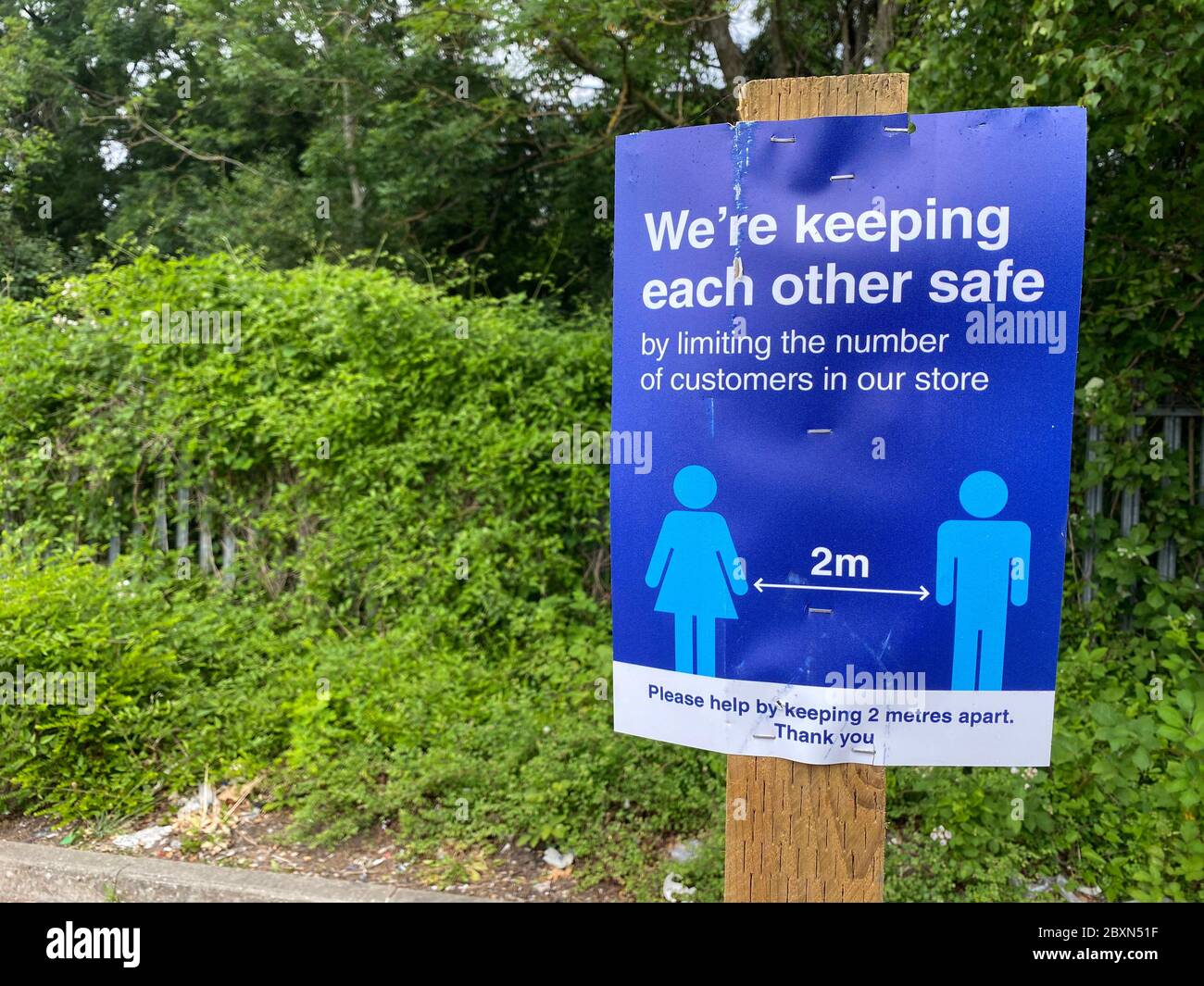 A social distancing poster warning people to stay 2 metres apart Stock Photo