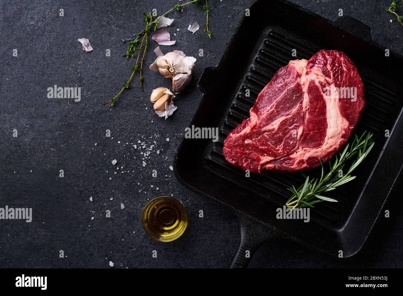 Top view Black Angus prime beef chuck roll steak on cast iron grill