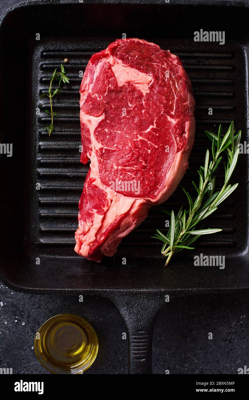 Top View Black Angus Prime Beef Rib Eye Steak On Cast Iron Grill Pan With Fresh Rosemary And Spices Creative Layout Stock Photo Alamy