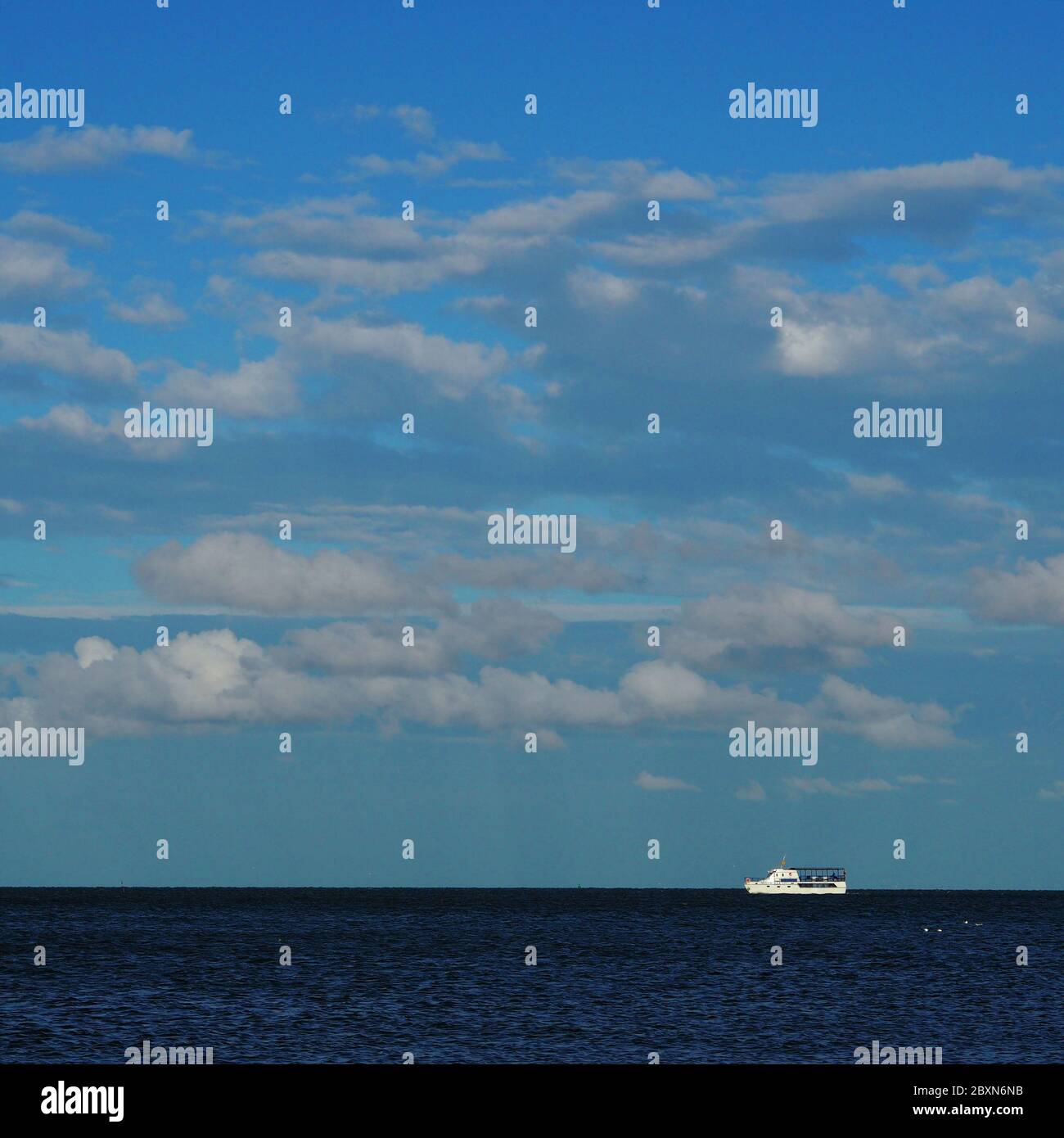 A ship at sea, in the blue sea against the sky. Aerial view of big luxury ship in sea, copyspace for text Stock Photo