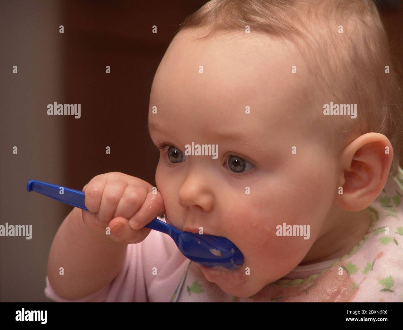 Toddler eats with spoon Stock Photo - Alamy