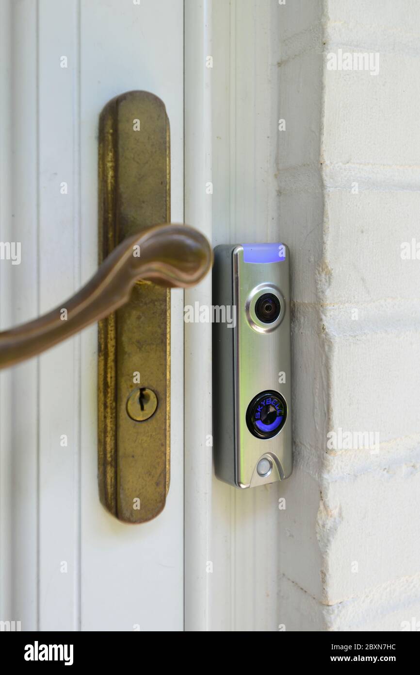 Video doorbell wifi enabled camera sends video of who is at the door to a smart device Stock Photo