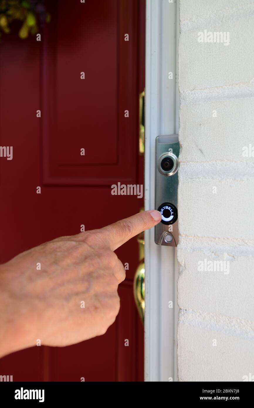 Video doorbell wifi enabled camera sends video of who is at the door to a smart device Stock Photo