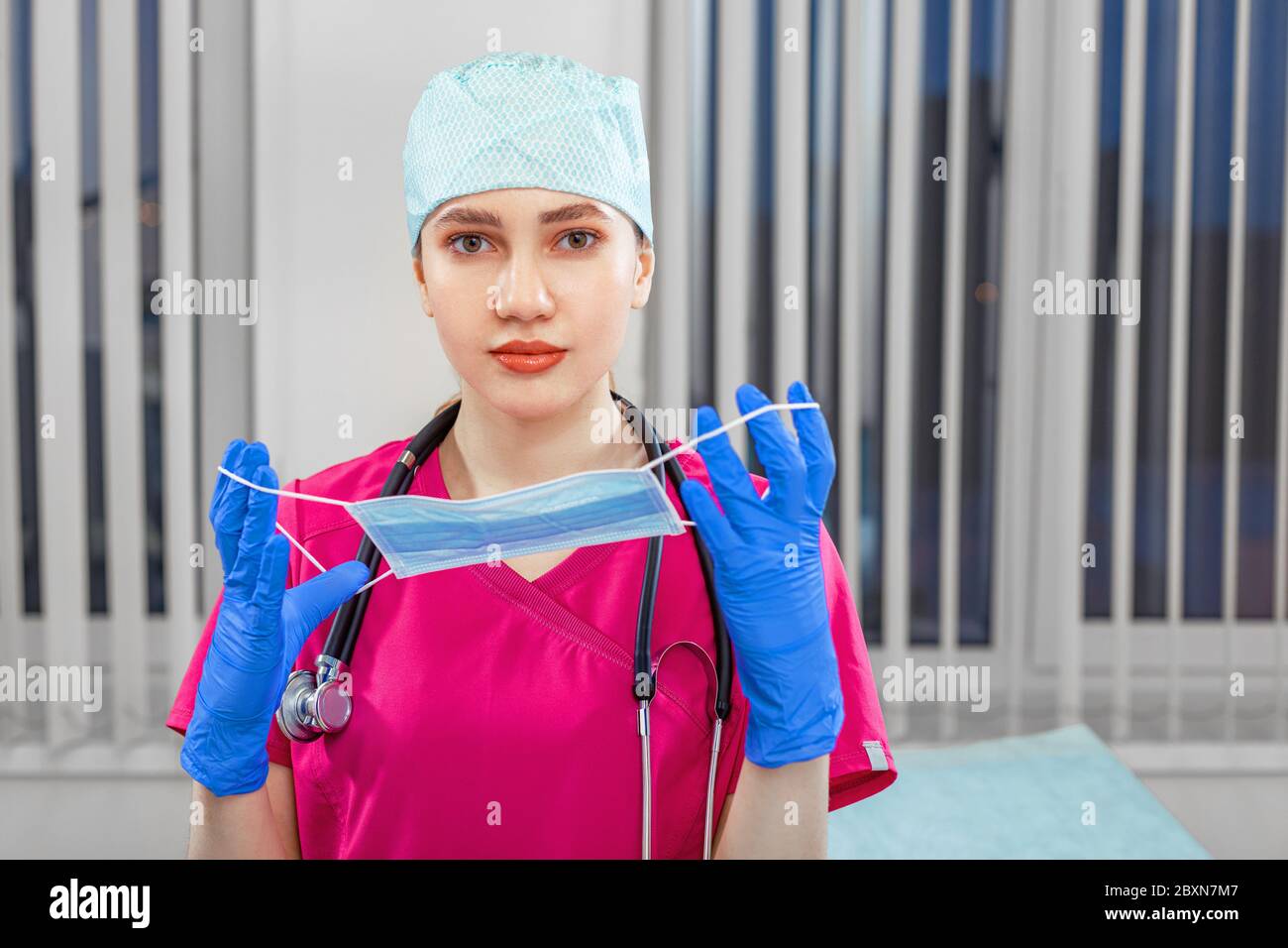 Female doctor takes off mask, victory over virus. The concept of