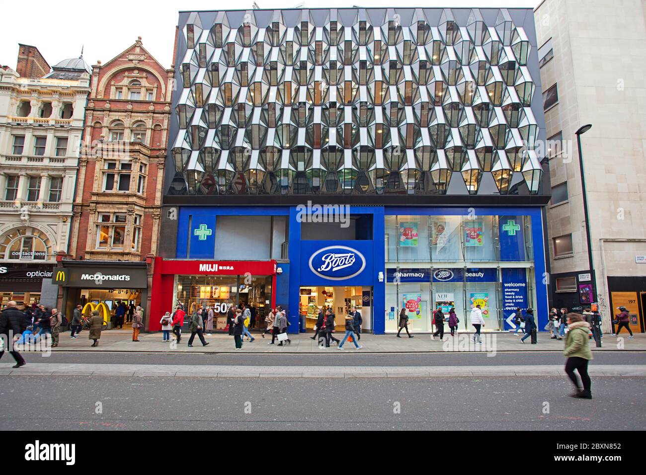 People walking past McDonalds, Boots and Muji stores on Oxford Street