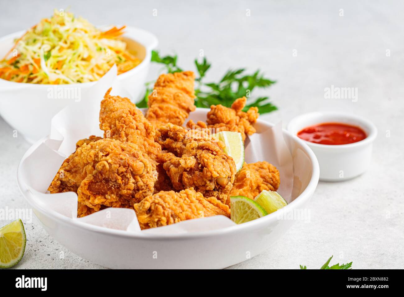 Crispy fried chicken in a white bowl. Stock Photo
