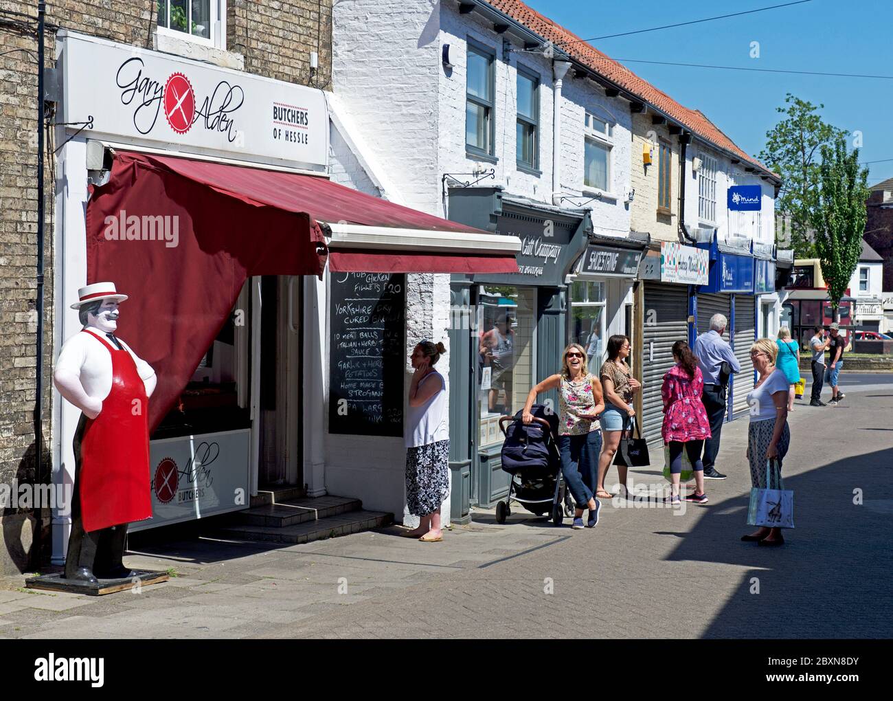 Customers queueing - social distancing - at a butchers shop in Hessle, near Hull, Humberside, East Yorkshire, England UK Stock Photo