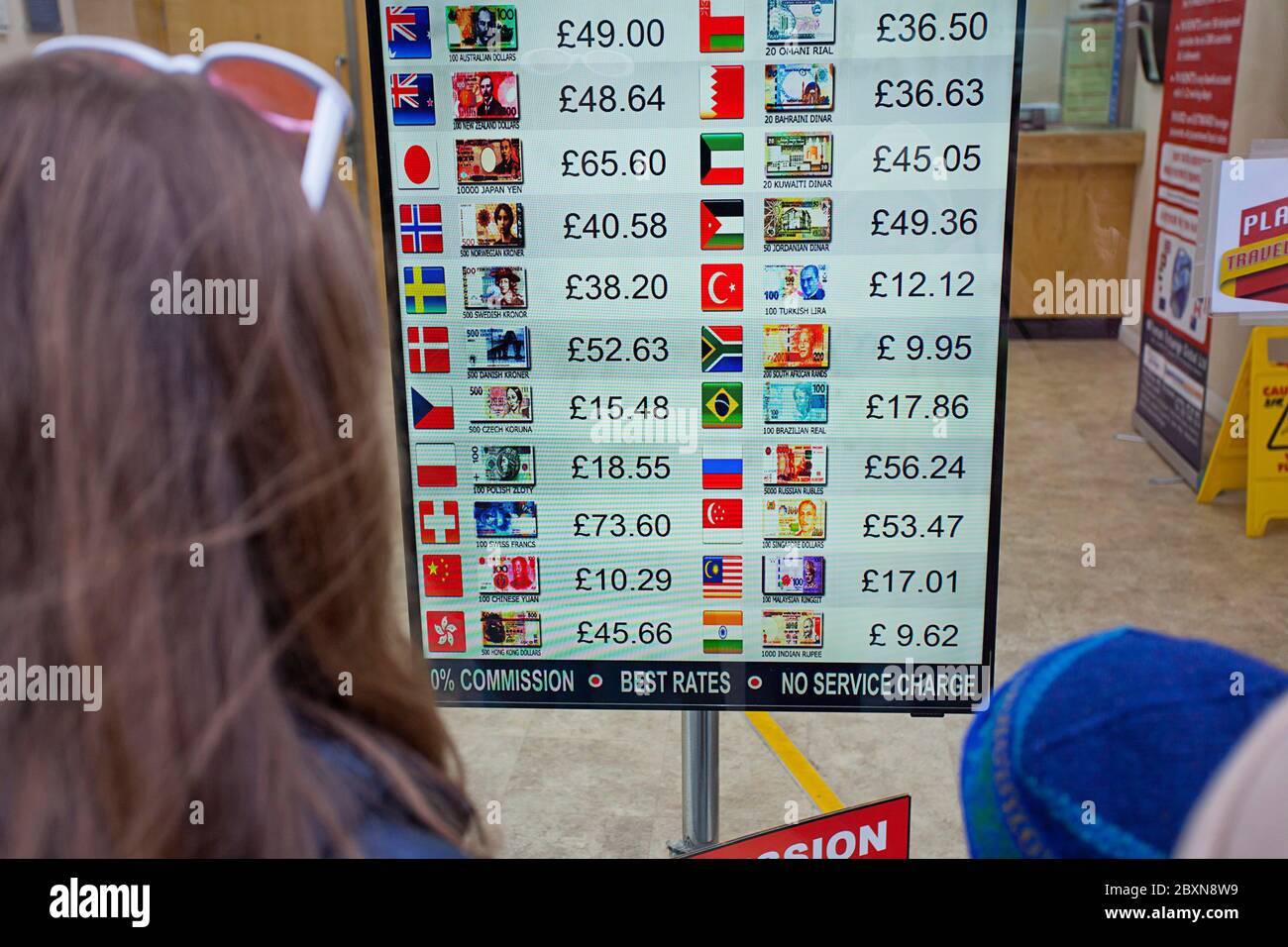 Looking at exchange rates on display Stock Photo