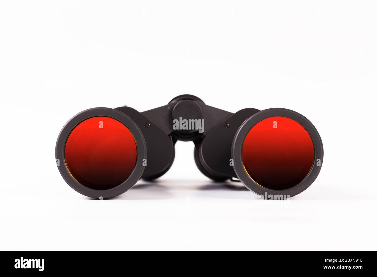 Black binoculars with orange lens isolated on white background Stock