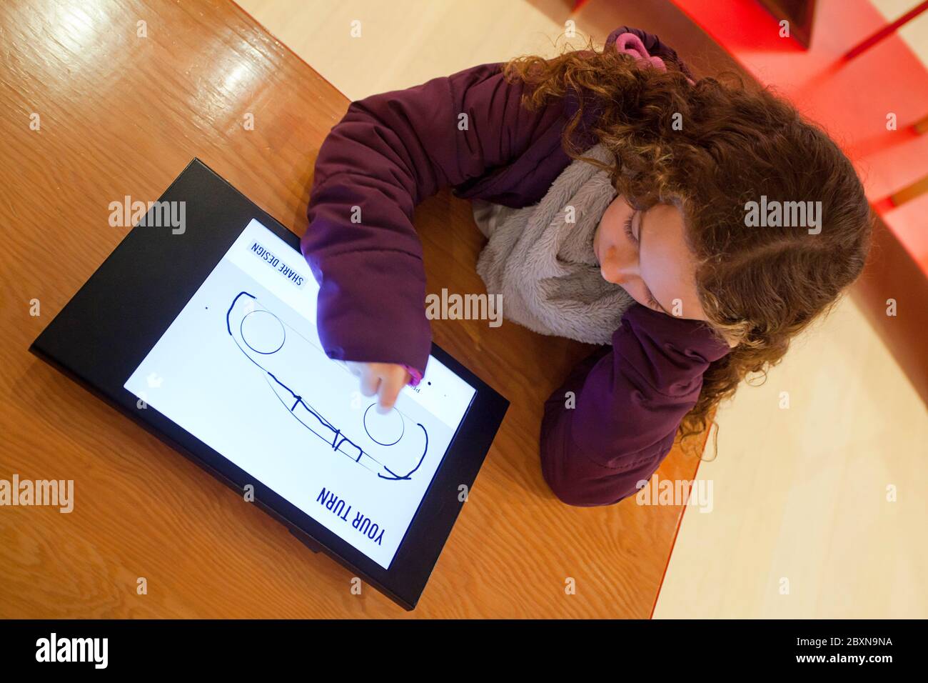 Girl designing car on tablet, The Design Museum, London Stock Photo