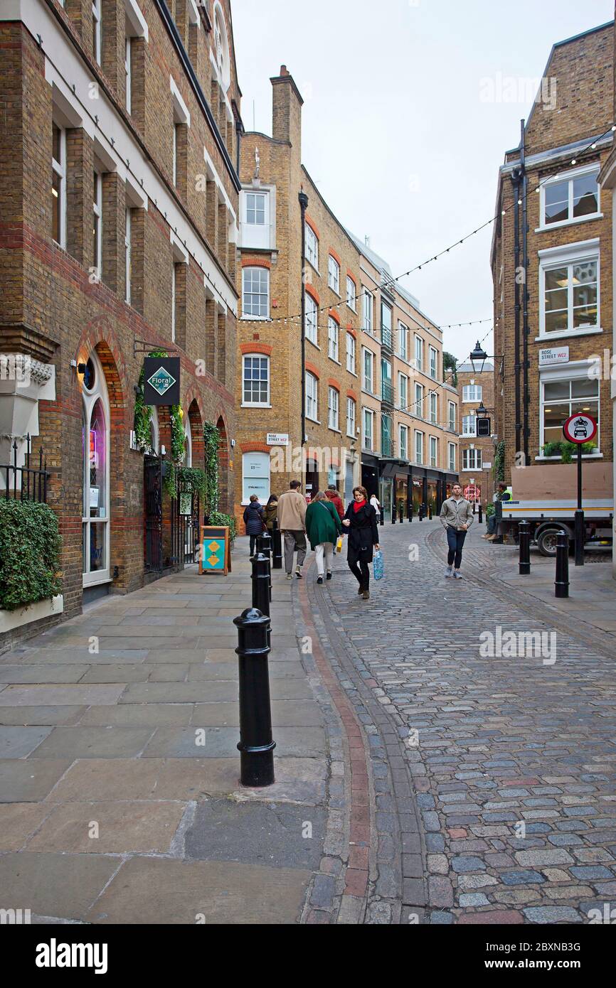 People walking down Floral St, Rose Street, London, U.K. Stock Photo