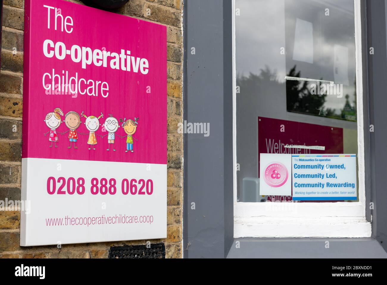 The name sign by the entrance to a Co-operative childcare nursury. Stock Photo