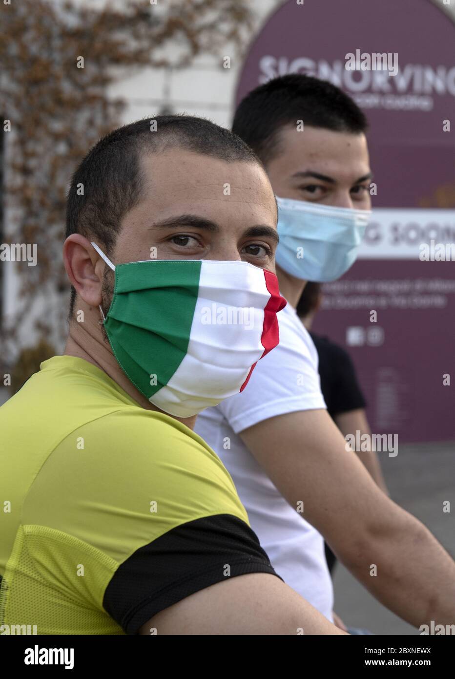 Youn men wearing italian healthy mask during to Covid-19 emergency, in Milan, Italy. Stock Photo