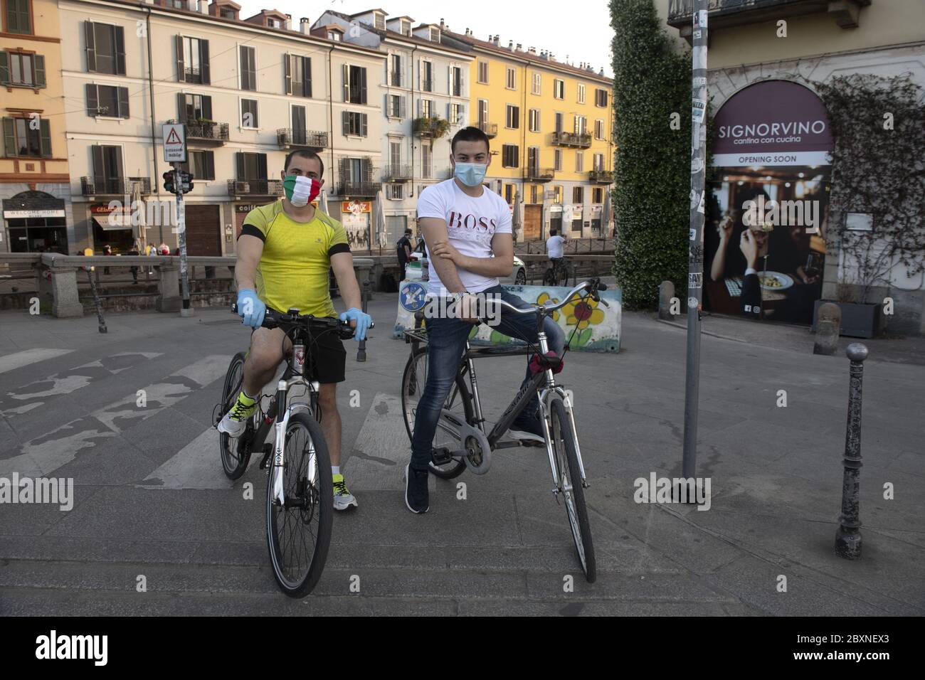 Young bycicle men wearing italian healthy mask during to Covid-19 emergency, in Milan, Italy. Stock Photo