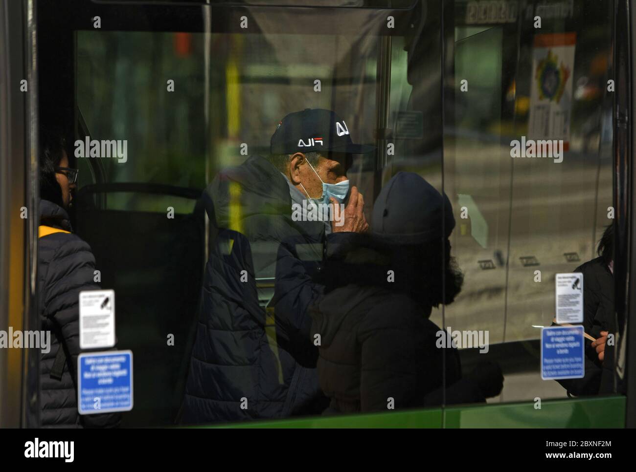 Man wearing face mask on public bus during the Covid-19 emergency, in Milan, Italy. Stock Photo