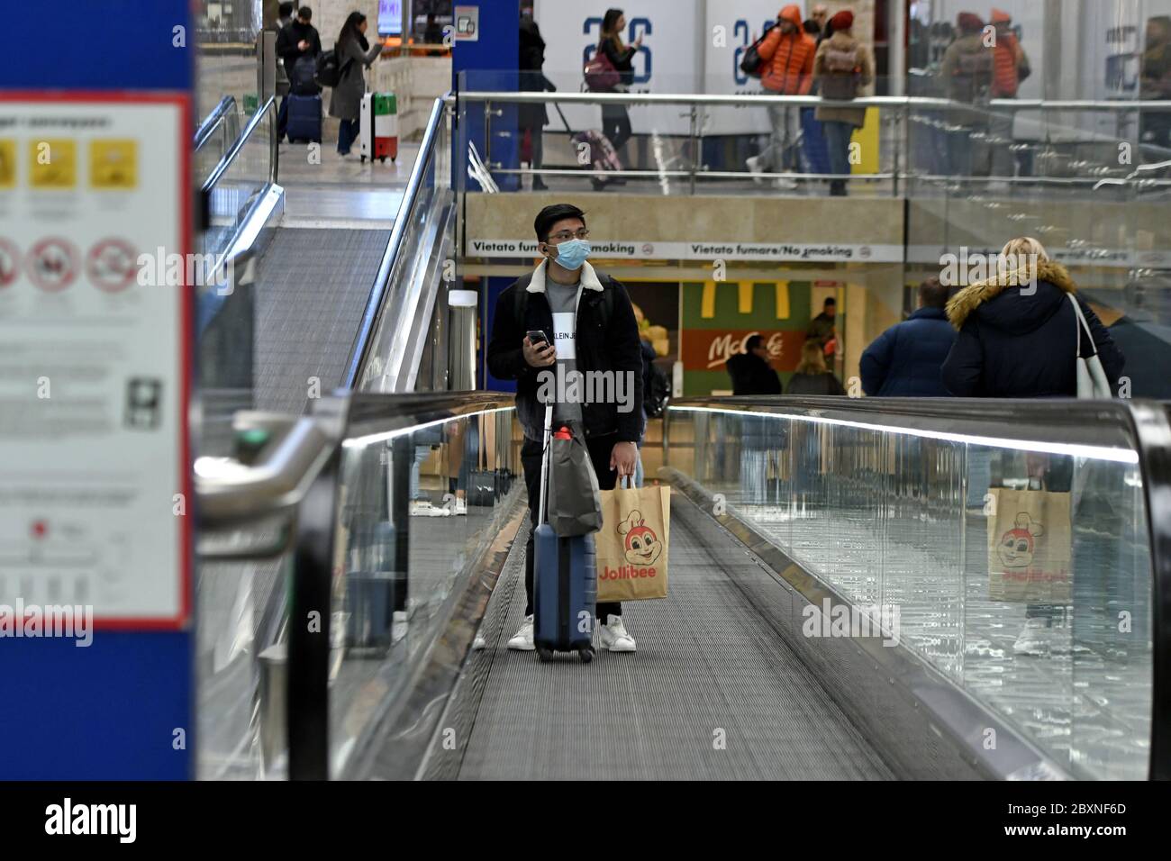 People wearing face mask at the Central Train station during the Covid-19 emergency, in Milan, Italy. Stock Photo
