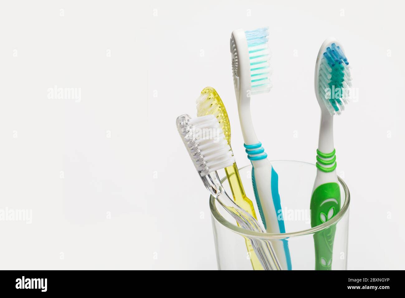 Set of colorful toothbrushes in glass on white background Stock Photo ...