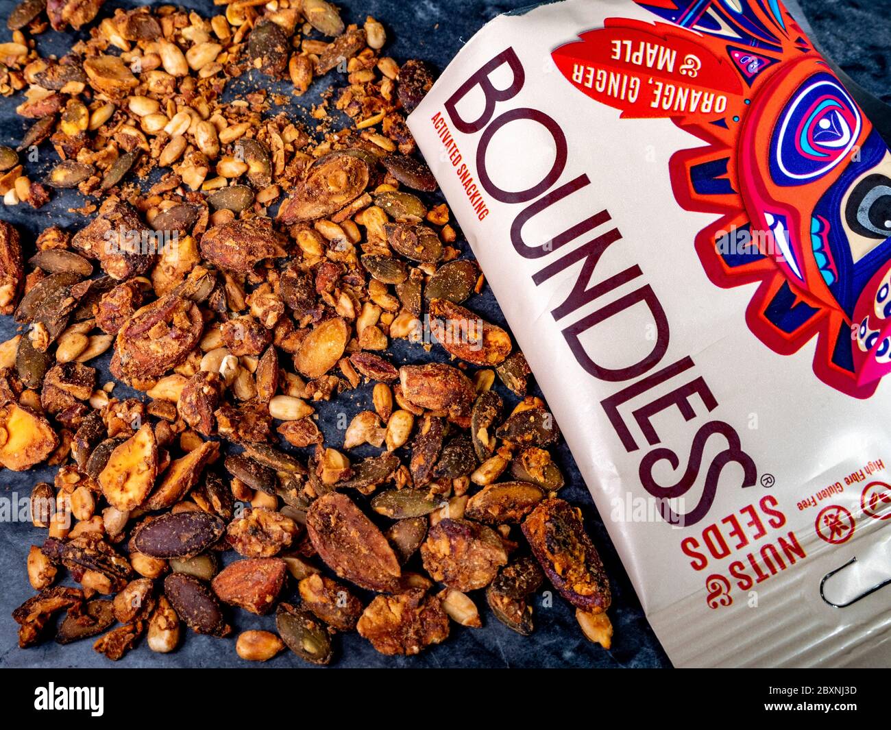 Nuts and seeds contents from a packet of Boundless nuts & seeds activated snacking, featuring orange, ginger and maple flavours. Stock Photo