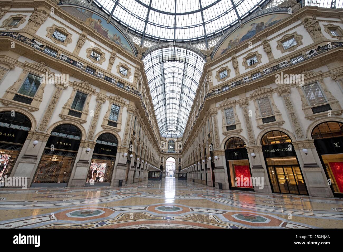 The emptiness of Galleria Vittorio Emanuele with shops closed during the lockdown caused by the Covid-19 in Milan, Italy. Stock Photo