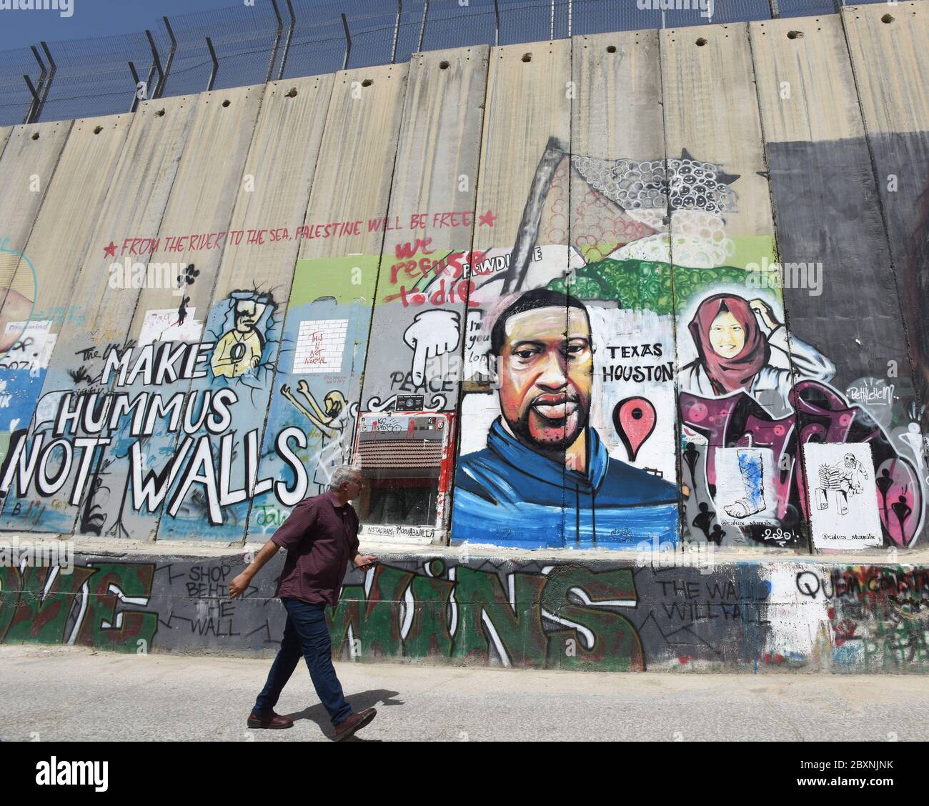 Bethlehem, West Bank. 08th June, 2020. A Palestinian looks at a graffiti mural of the late George Floyd on the Israeli separation wall in Bethlehem, West Bank, on Monday, June 8, 2020. Floyd, 46, an unarmed African American, died on May 25, in Minneapolis, Minnesota, after a white police officer Derek Charvin forcefully knelt on his neck for nearly nine minutes while Floyd pleaded that he couldn't breathe. Photo by Debbie Hill/UPI Credit: UPI/Alamy Live News Stock Photo