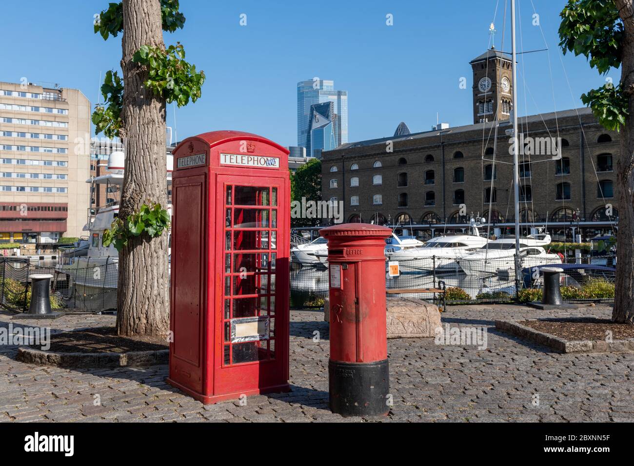 St. Katherine Dock Marina with red telephone and post box in the foreground. Stock Photo