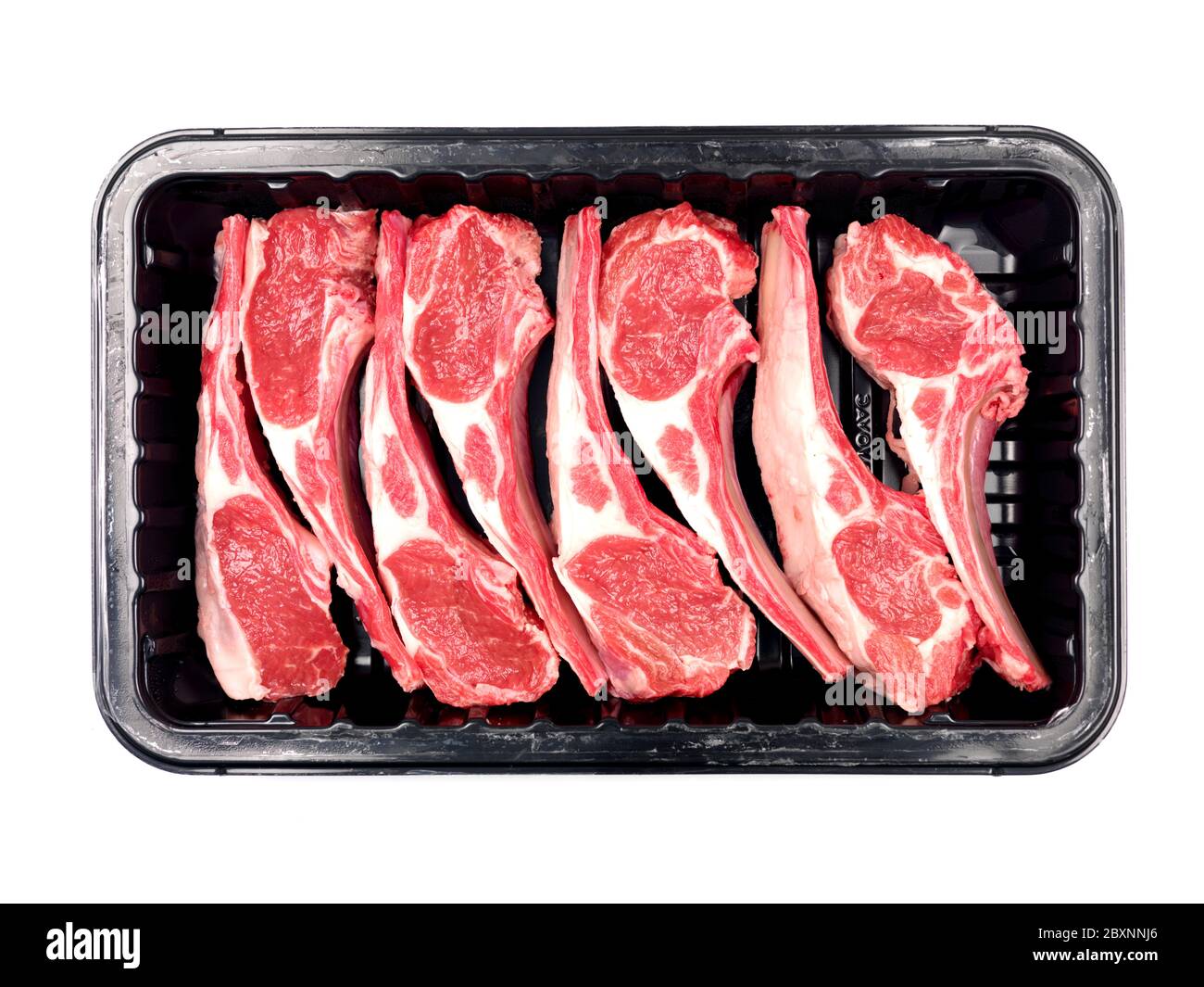Supermarket packaged lamb chops isolated against a white background