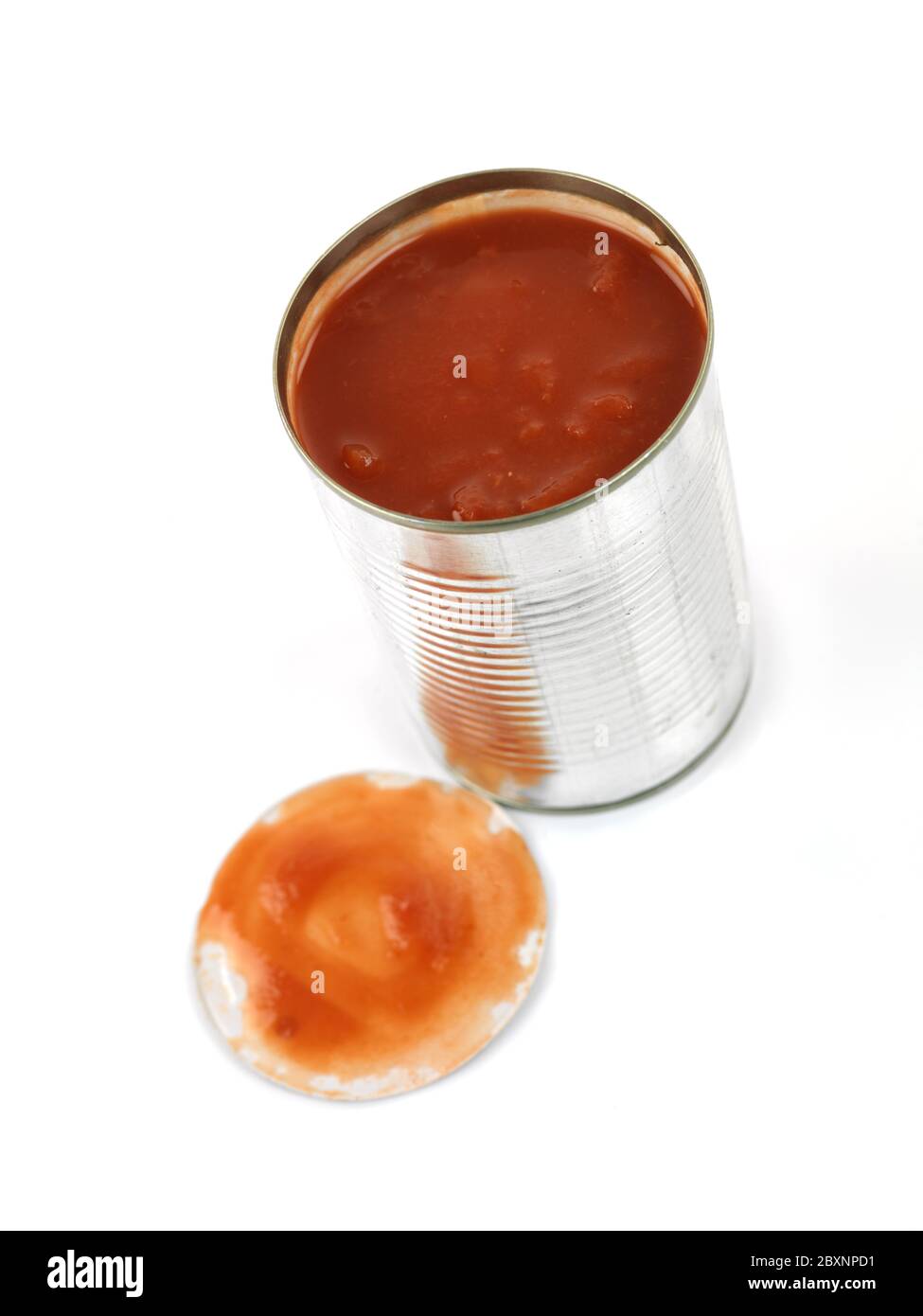 A can opener and a tin can isolated against a white background Stock Photo