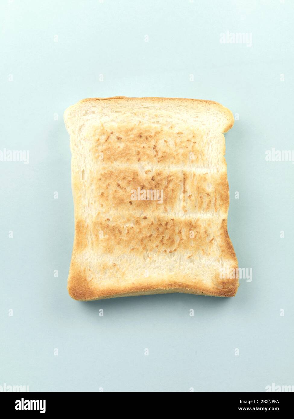 Plain white toast isolated against a pale blue background Stock Photo