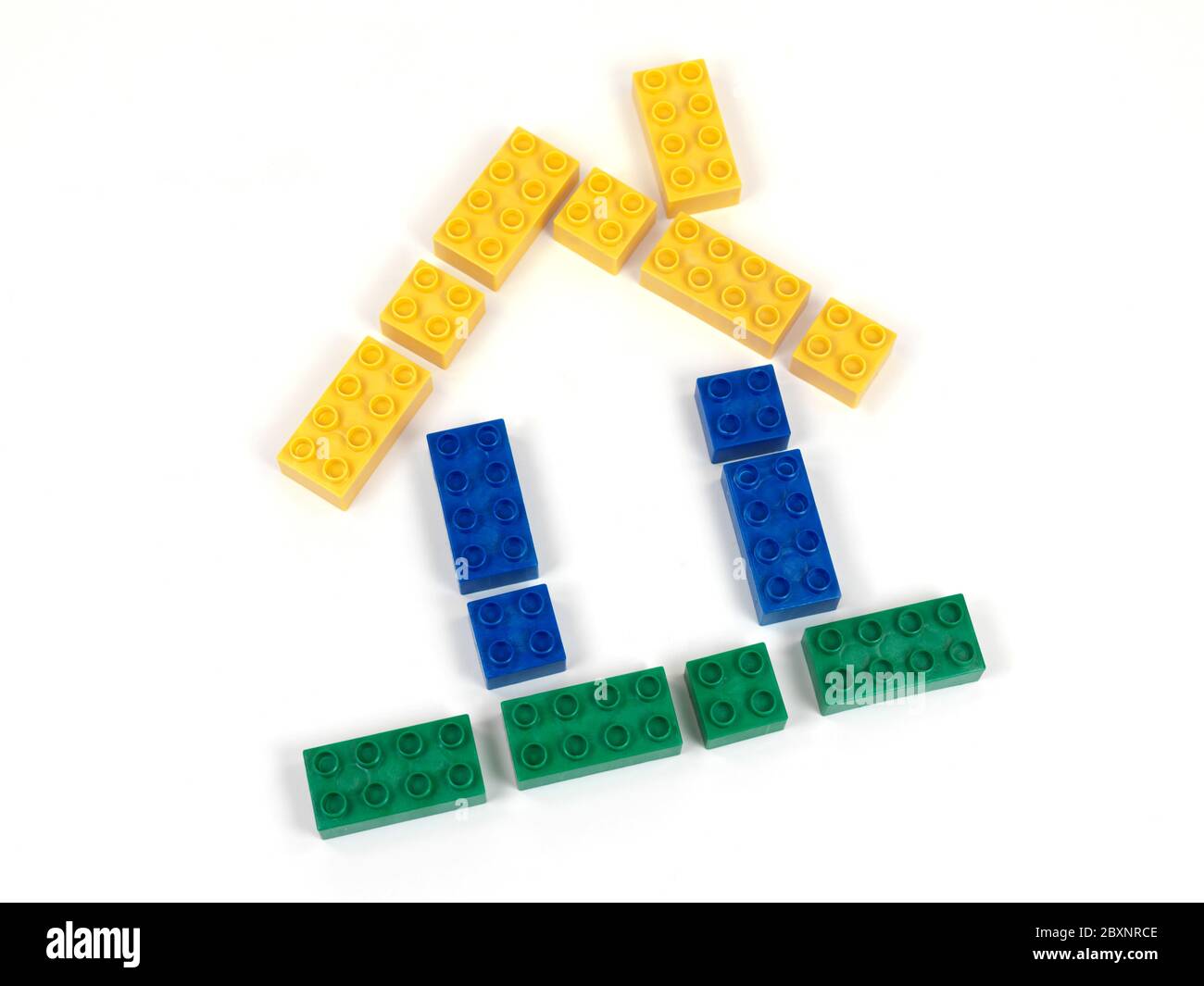 A toy house made from toy blocks isolated against a white background