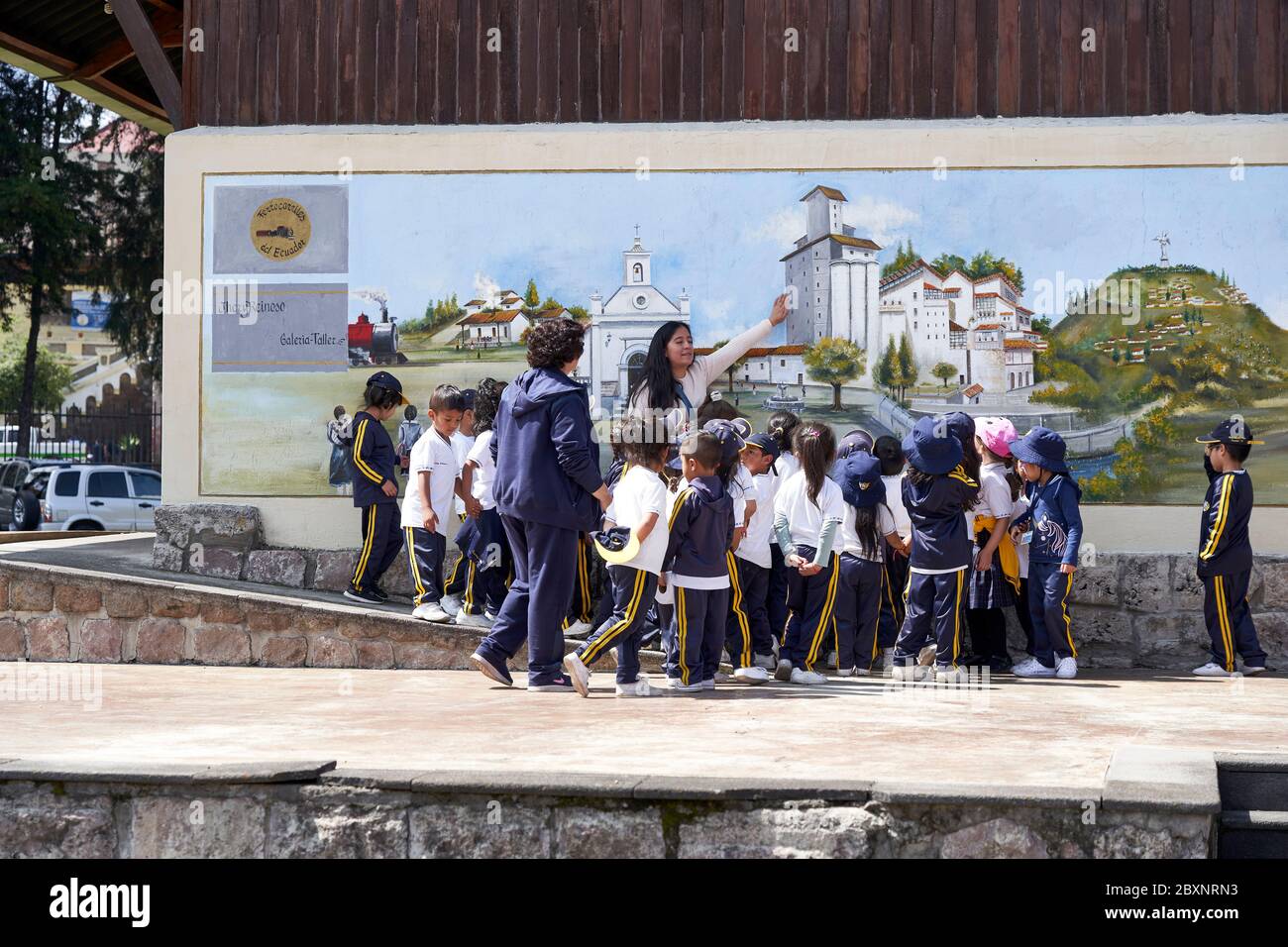 Teacher with school children at Chimbacalle railway station in Quito, Ecuador Stock Photo