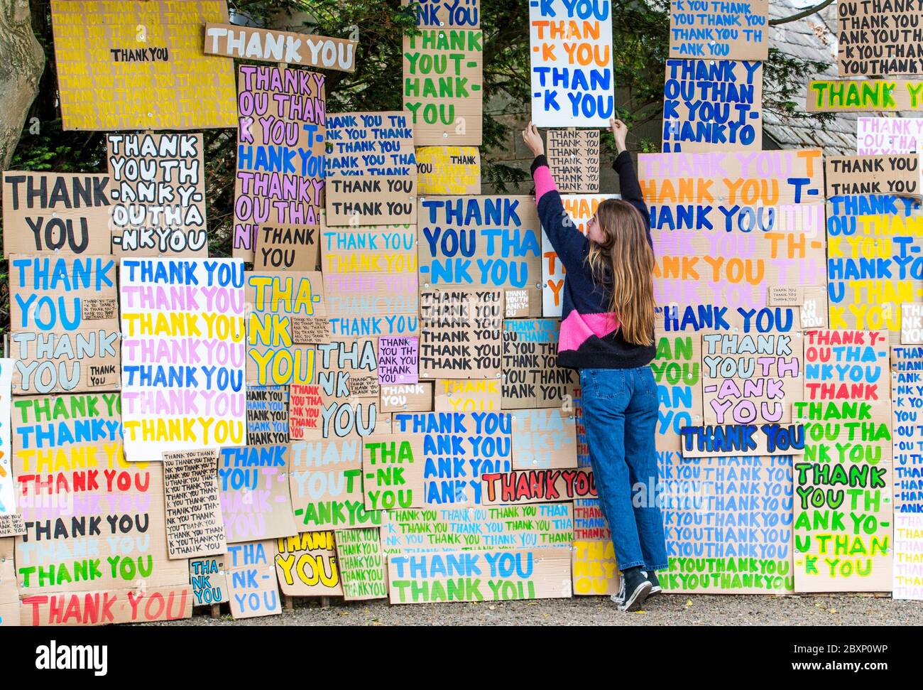 Hermione Wilson helps to install a new artwork at Jupiter Artland, Edinburgh, created as a tribute to the NHS titled 'A Thousand Thank Yous' originally devised by the late Allan Kaprow which consists of colourful painted messages on cardboard and has been directed remotely by London-based artist Peter Liversidge. Stock Photo