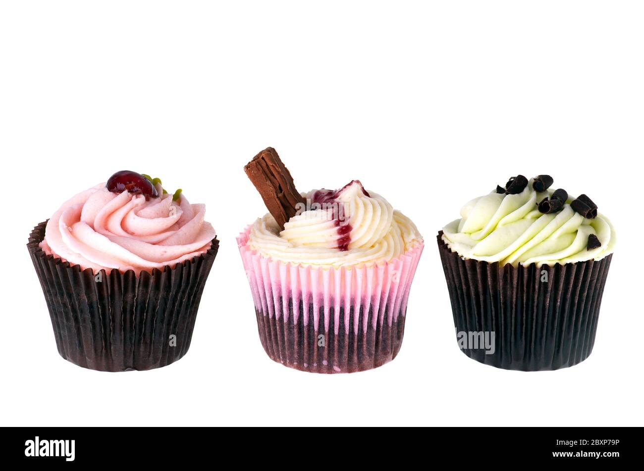 Three fancy cupcakes isolated on white background with space for text. Stock Photo