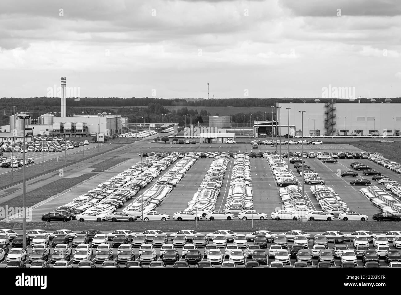 Volkswagen Group Rus, Russia, Kaluga  - MAY 24, 2020: Rows of a new cars parked in a distribution center on a cloudy day in the spring and a car facto Stock Photo