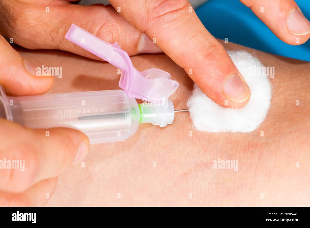 A doctor take a blood sample from a patients arm Stock Photo