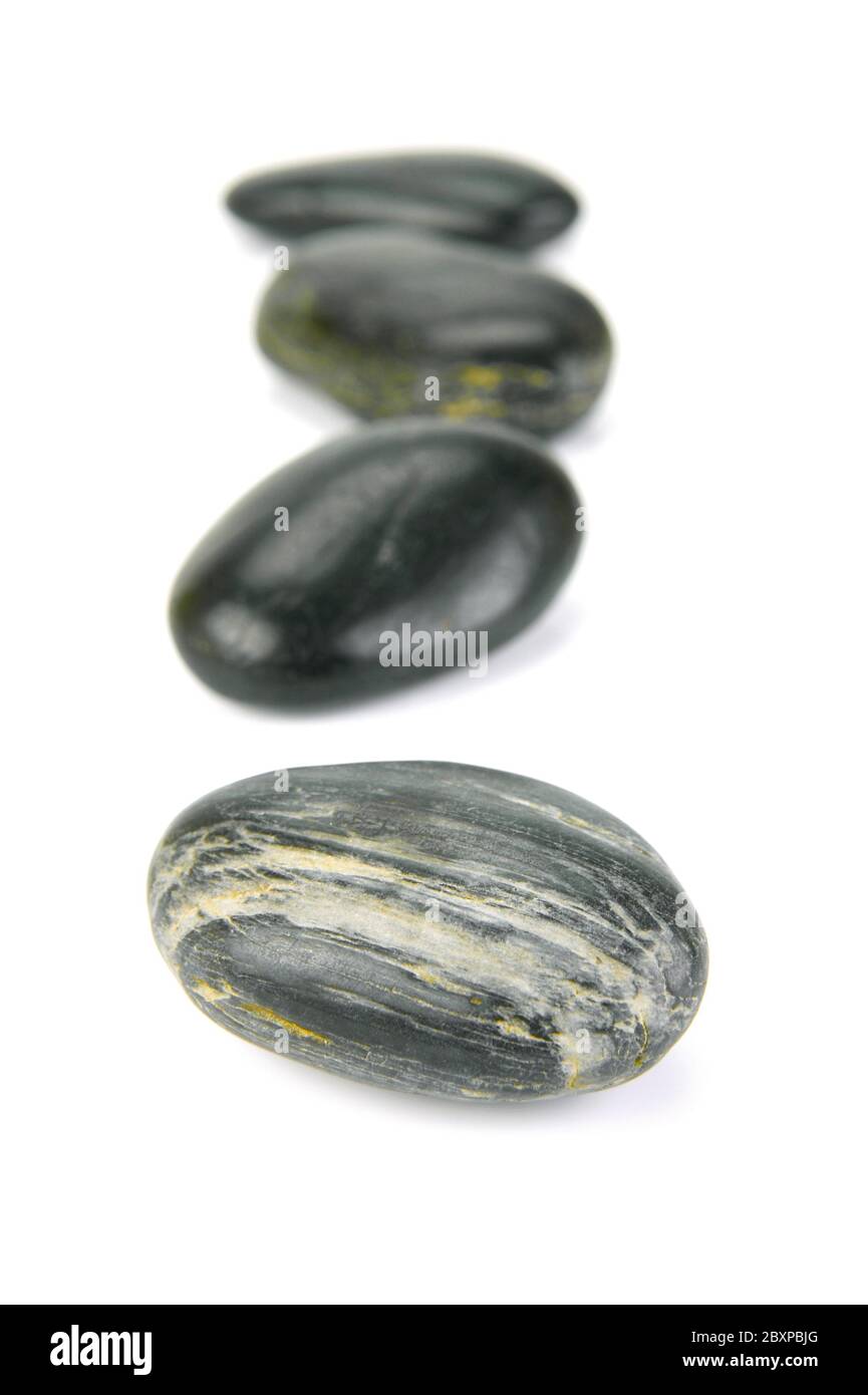 Black river rocks isolated against a white background Stock Photo