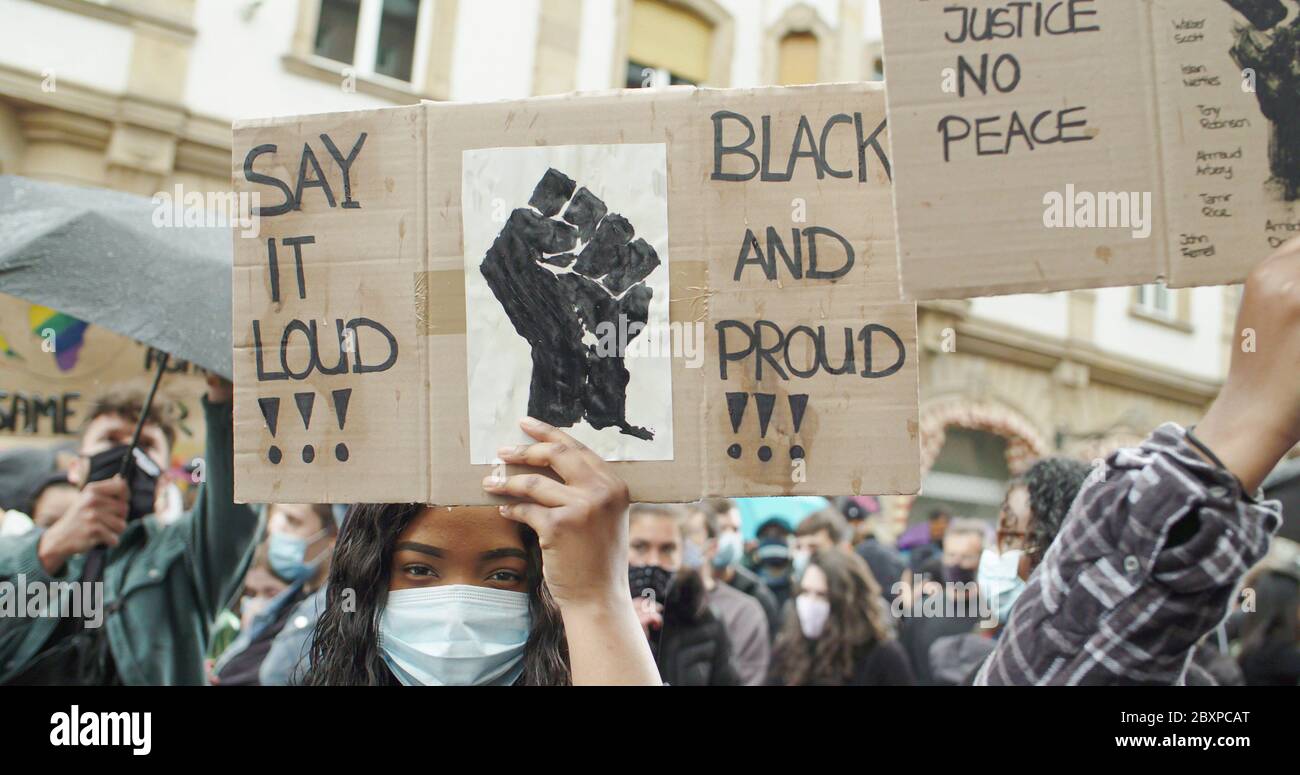 Black Lives Matter Rally, Frankfurt, Germany. June 6th 2020. Young black woman holding up black lives matter sign at demonstration. Stock Photo