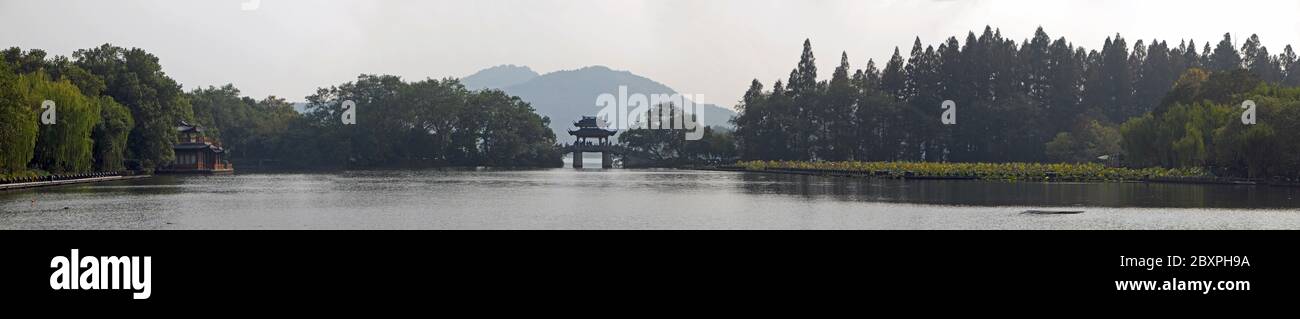 West Lake (Xi Hu) in Hangzhou, Zhejiang Province, China. Panoramic view of Yudai bridge on West Lake, one of the famous symbols of Hangzhou city. Stock Photo