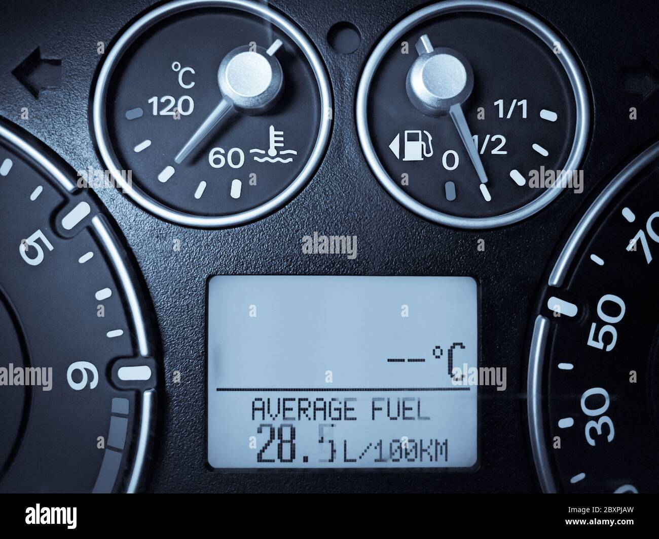 Close up image of a car's dashboard indicating a very high fuel consumption Stock Photo Alamy